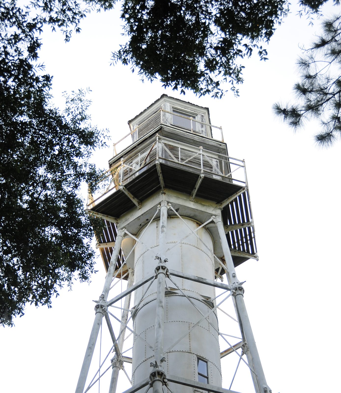 Hilton Head Rear Range Lighthouse, a white cast-iron skeleton tower rising through trees at Leamington